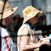 Art fair goers attempt to shade the hot sun while wearing hats as they walk down S. Thompson St. on Wednesday, July 17, 2013. Melanie Maxwell | AnnArbor.com